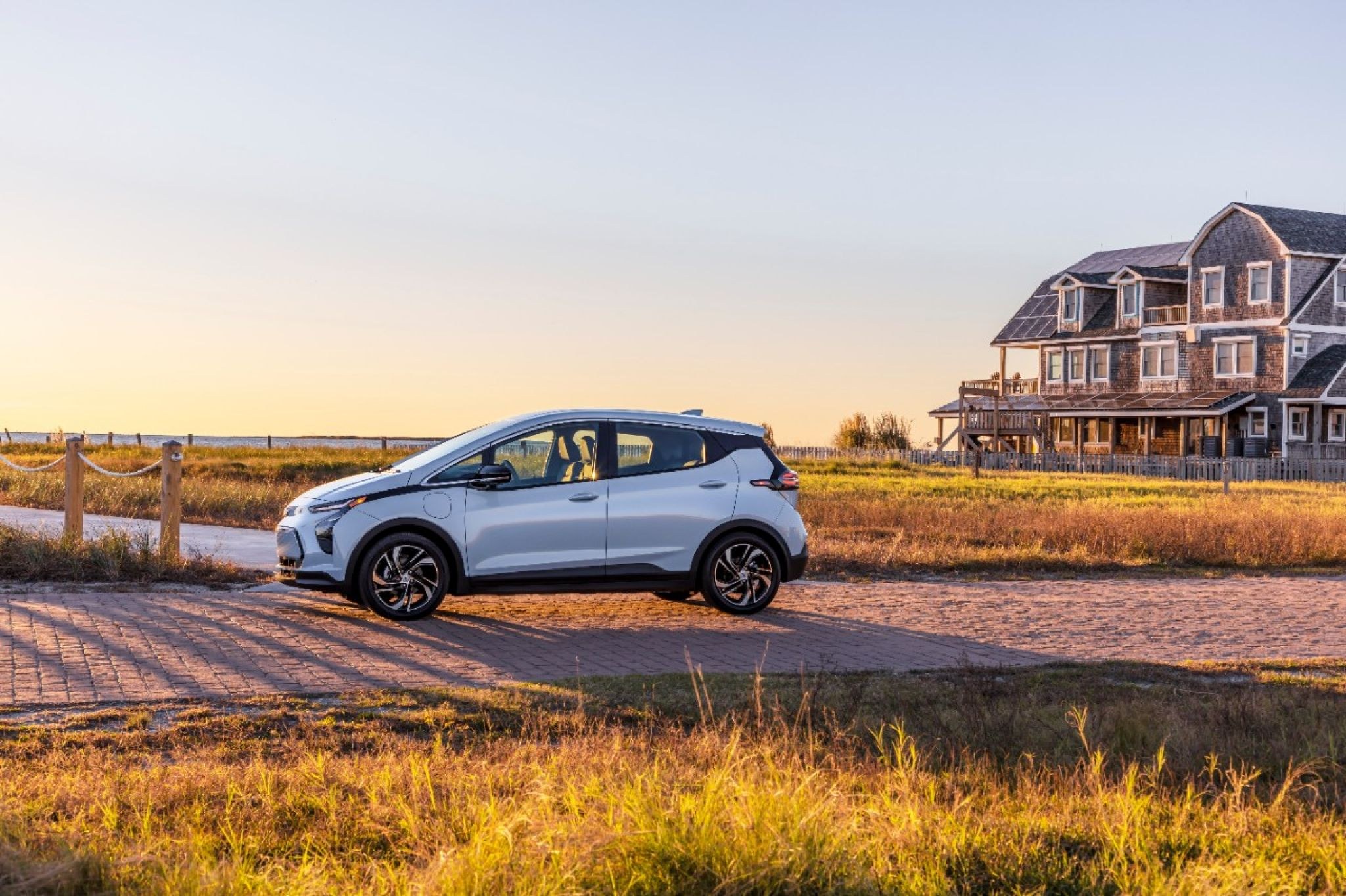 2022 Chevrolet Bolt EV side profile at sunset, one of the 2017-2022 model years recalled for battery fire risk