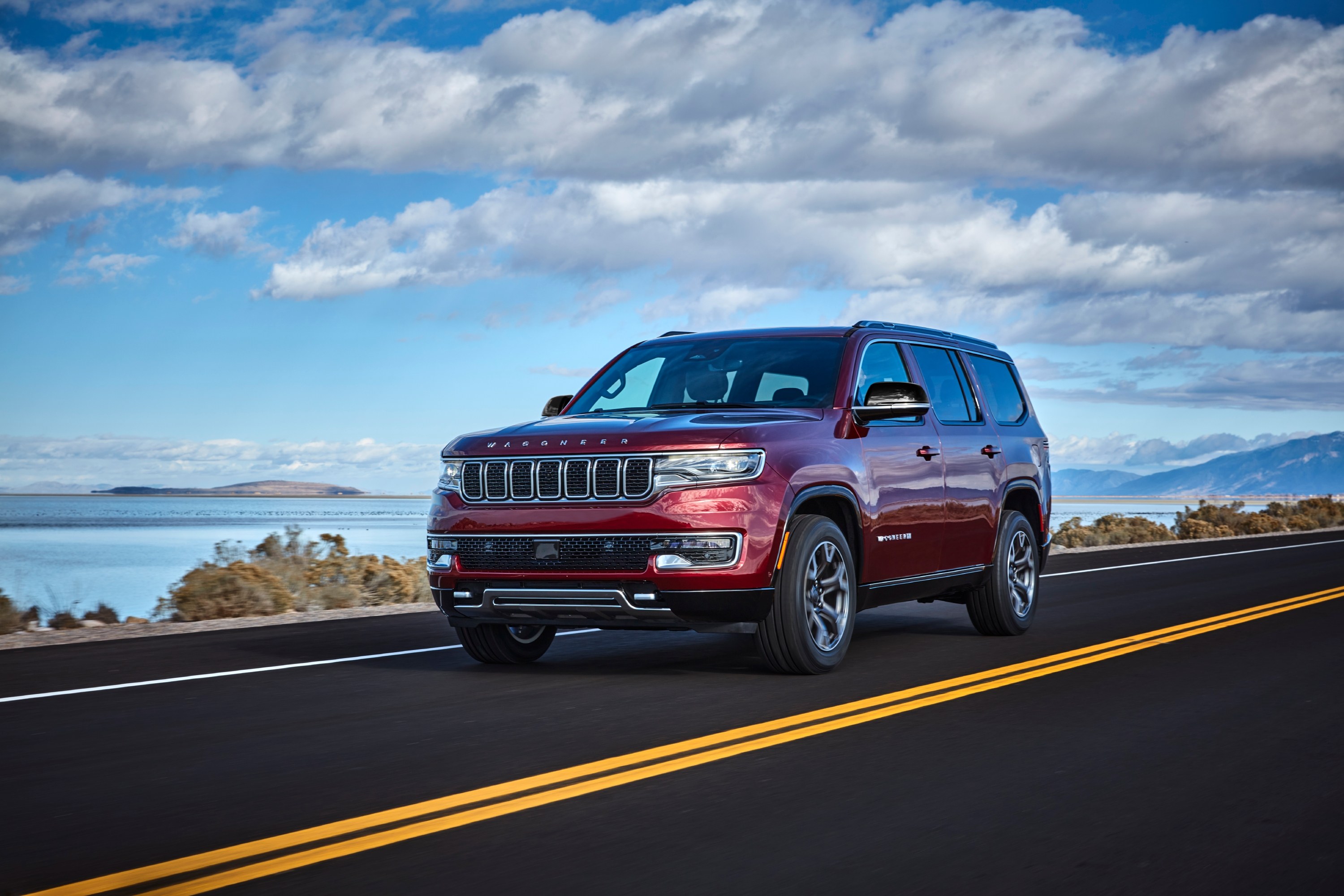 2024 Jeep Wagoneer in red, front three-quarter driving view; the 2024 Wagoneer is in recall 26V559 over tire pressure monitoring software