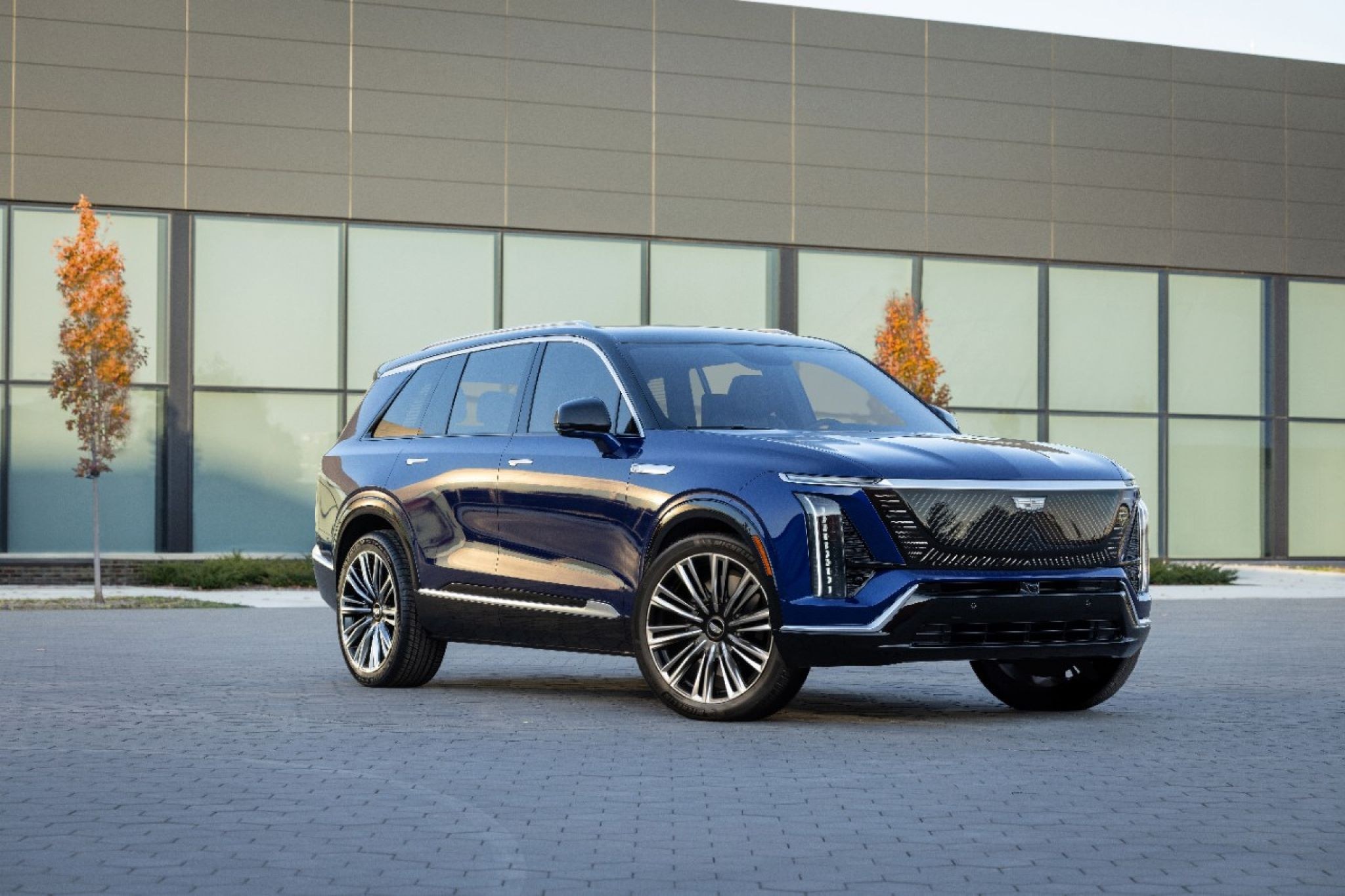 2026 Cadillac Vistiq in Opulent Blue, front three-quarter view, the three-row electric SUV recalled under campaign 26V394000 over a third-row power-folding seat that can trap a child