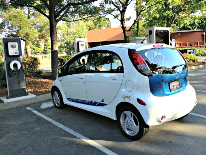 A Mitsubishi MIEV, one of the early modern EVs, getting re-charged at a public electric vehicle station in Concord, California.