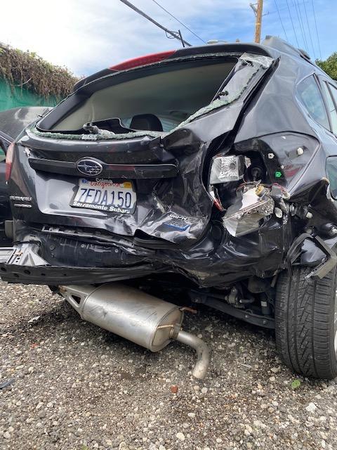 The aftermath of an accident in Los Angeles involving a Subaru Impreza hatchback.