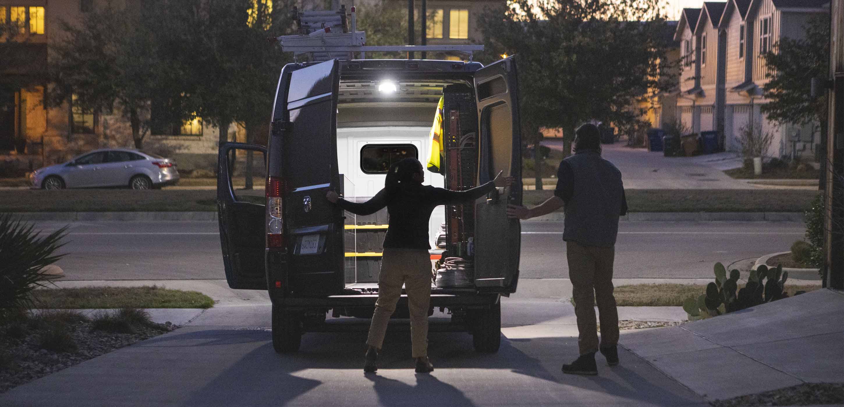 2025 RAM ProMaster 2500 rear doors open showing illuminated cargo area at night