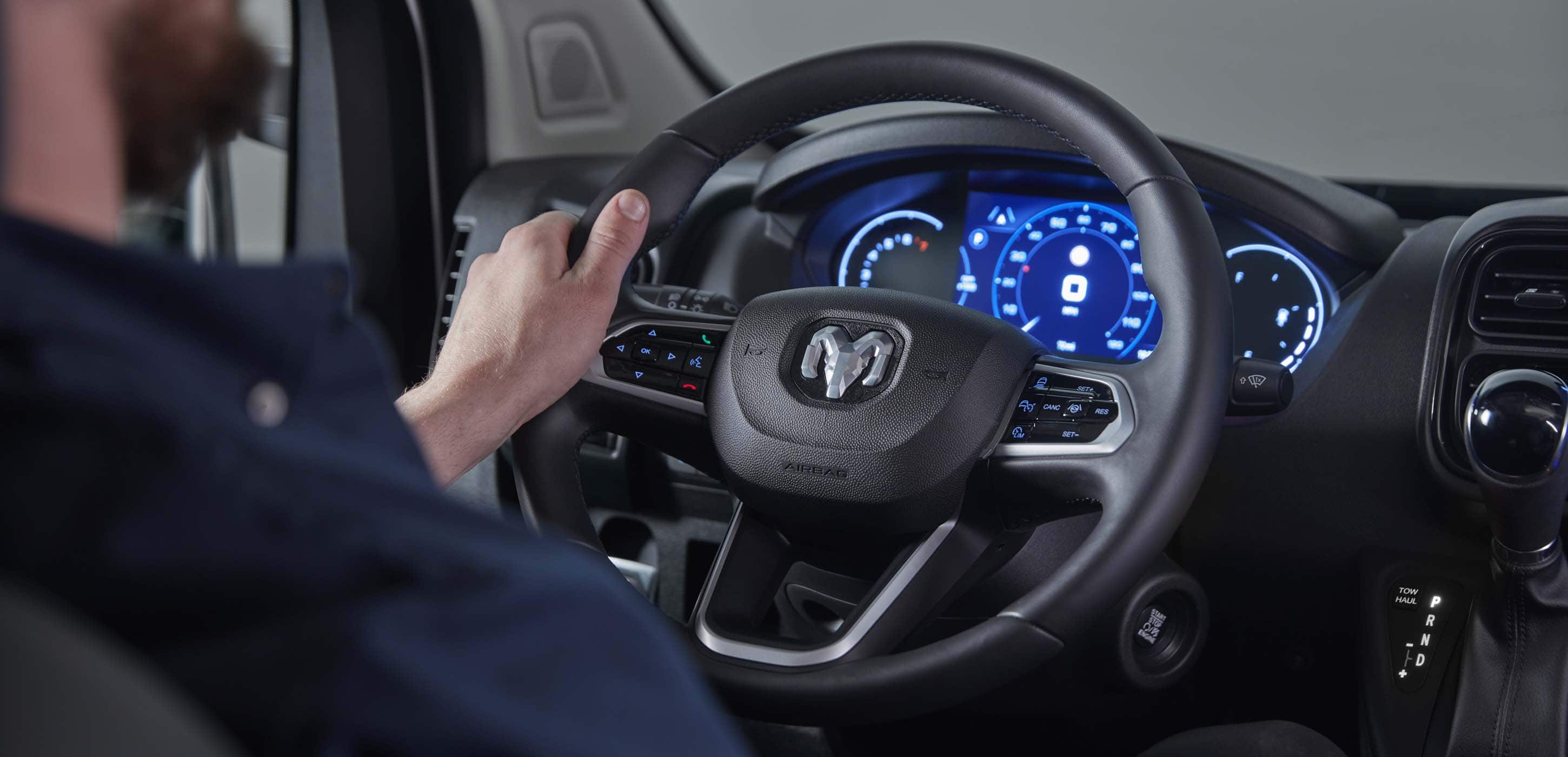 2025 RAM ProMaster 2500 steering wheel, digital instrument cluster, and 10.1-inch Uconnect touchscreen