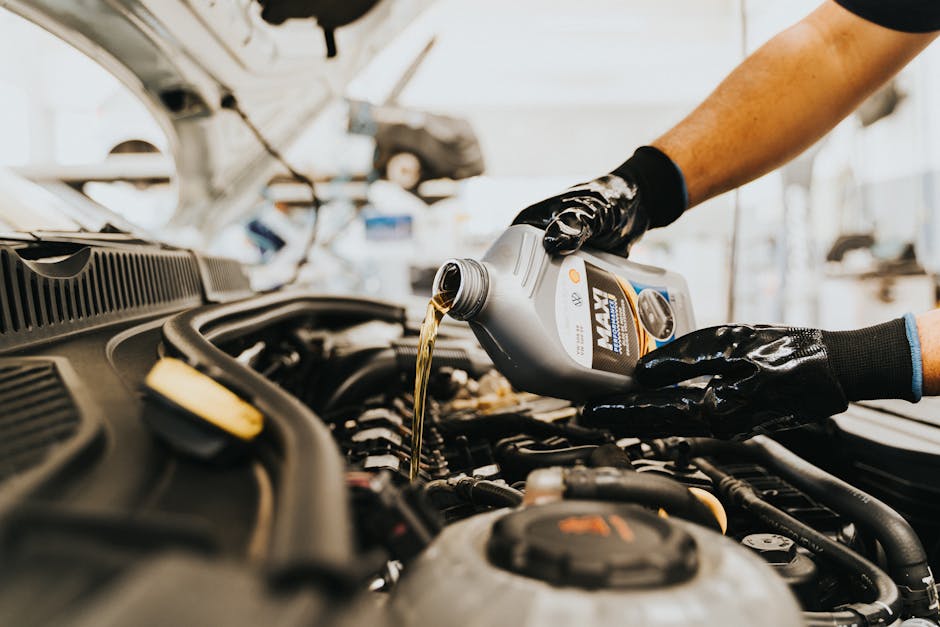 Mechanic pouring fresh engine oil during a DIY oil change