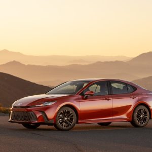 2026 Toyota Camry SE AWD hybrid sedan in Supersonic Red, exterior front three-quarter view