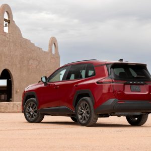 2026 Toyota RAV4 Hybrid XLE Premium AWD in Ruby Flare Pearl photographed at a lakeside overlook