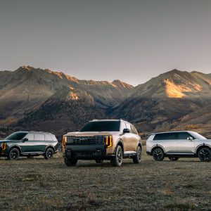 2027 Kia Telluride X-Line, X-Pro, and SX-Prestige lineup photographed in a mountain meadow at golden hour