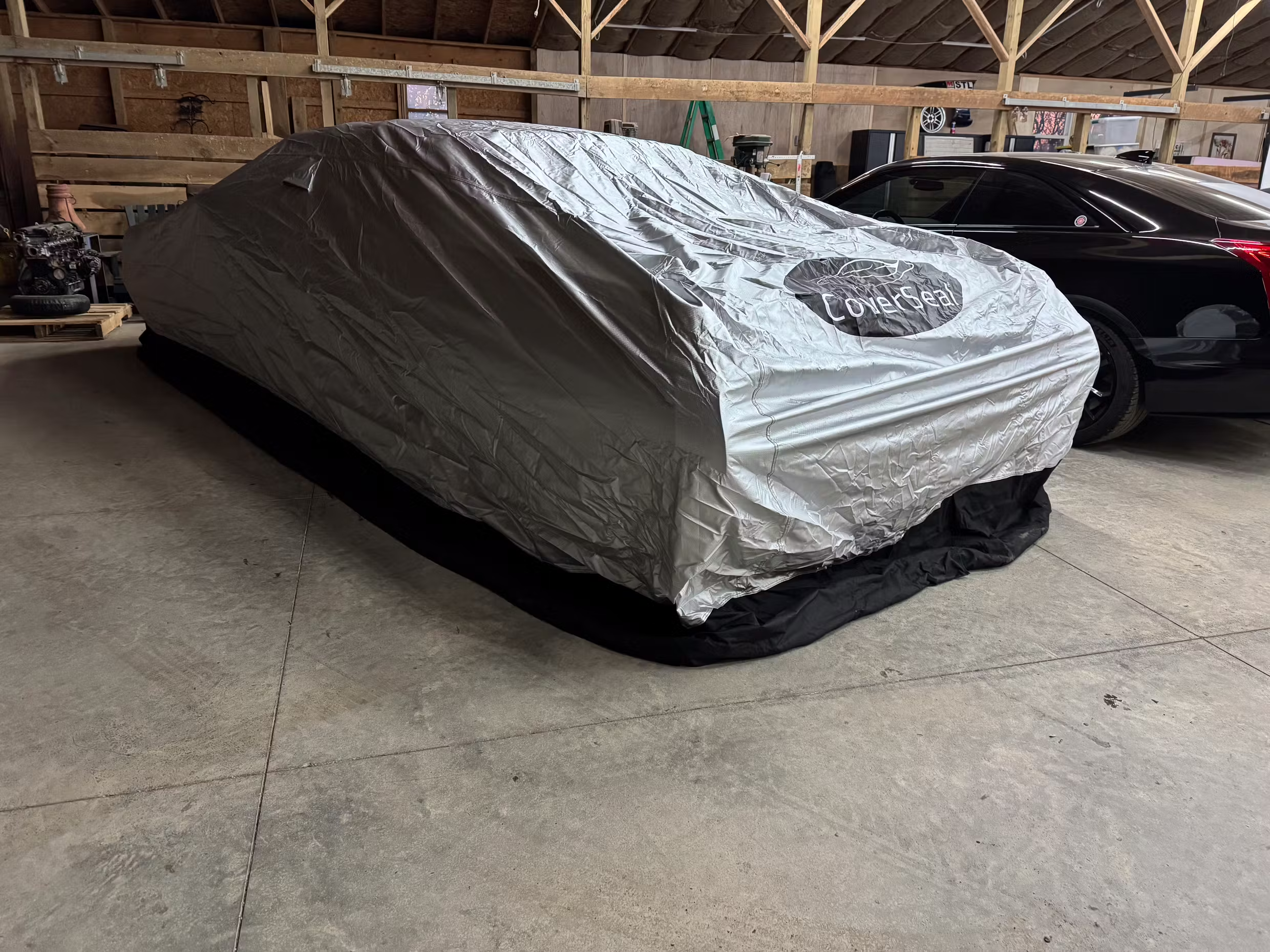 CoverSeal weighted car cover sealed to the ground around a parked vehicle for rodent protection