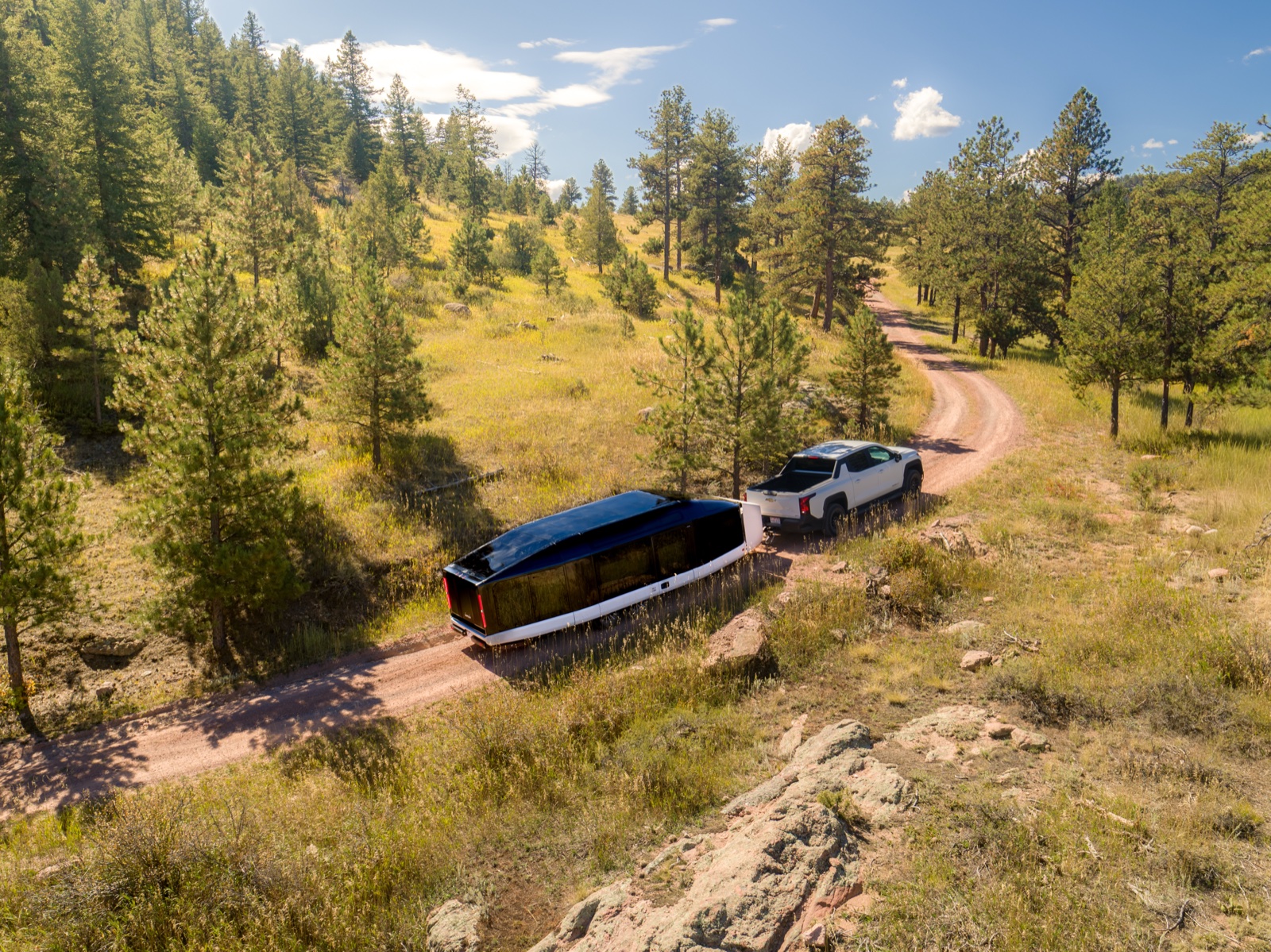 Lightship AE.1 in Road Mode being towed by an electric pickup truck on a highway