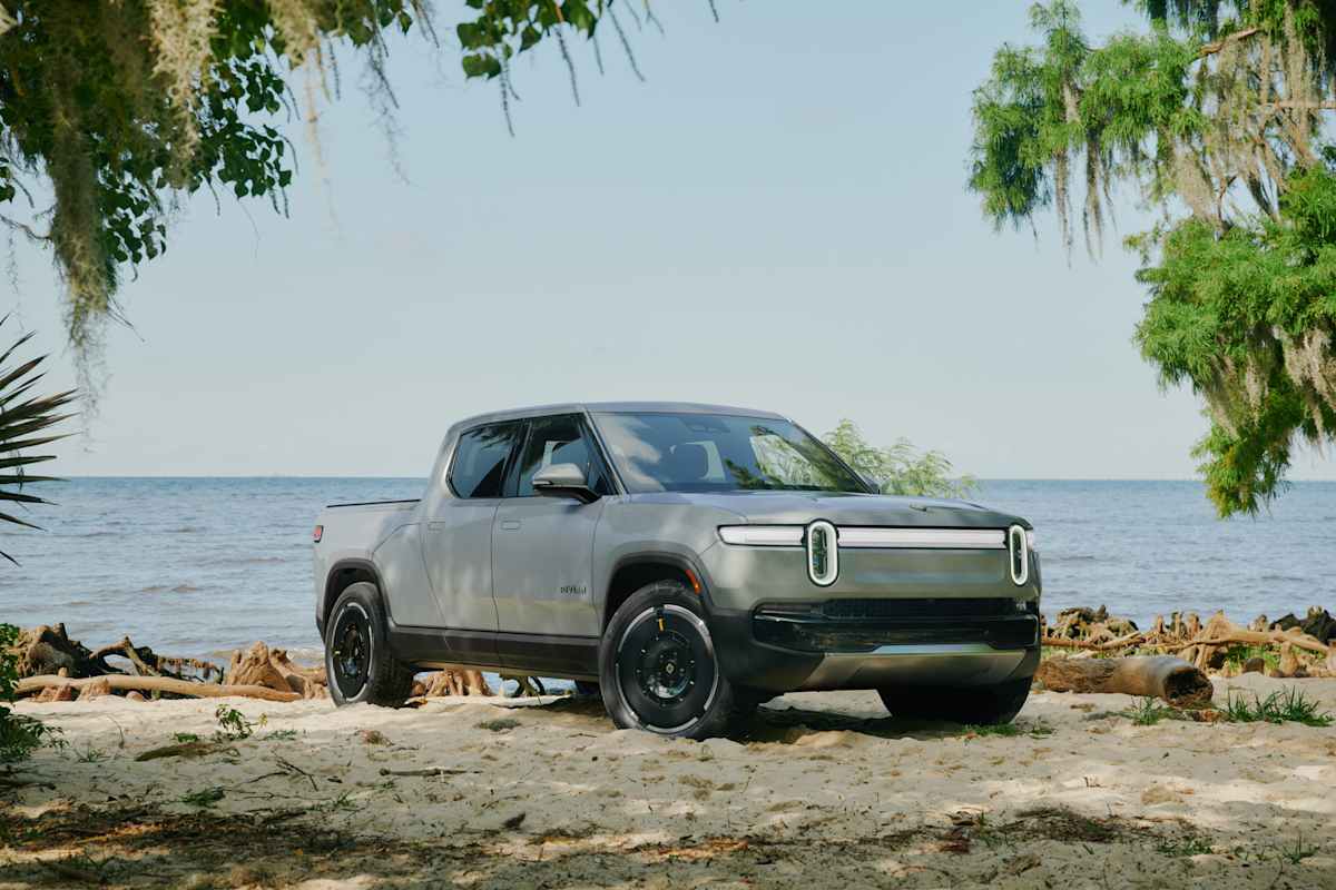 2026 Rivian R1T in gray at beach waterfront with Spanish moss trees