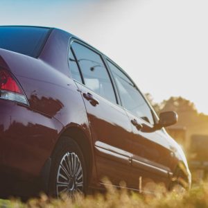 Modern sedan on open road at sunset representing used car reliability research