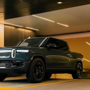 Gen-2 Rivian R1T electric truck parked inside an architectural covered structure
