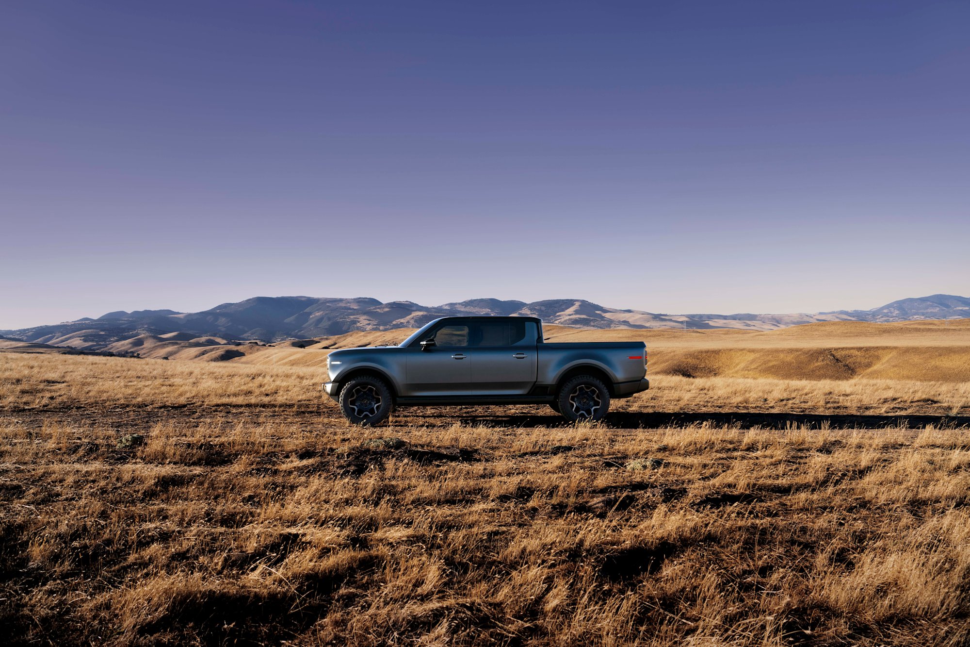 Scout Terra side profile against golden hills showing full body length and bed