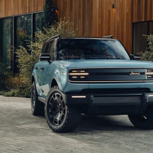 Scout Traveler SUV in blue-sage paint, front three-quarter view, parked in an urban setting