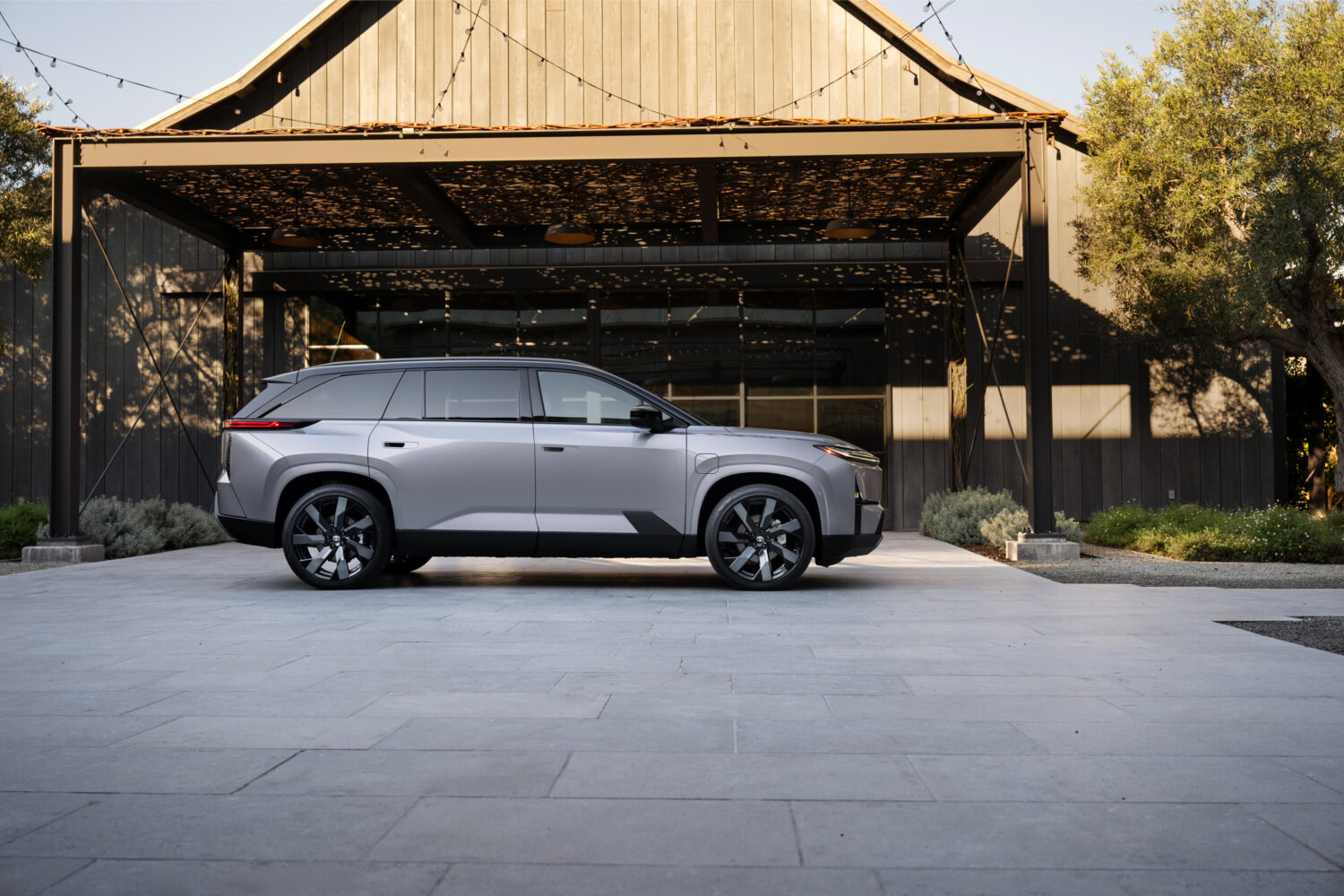 2027 Toyota Highlander EV rear three-quarter view in Spellbound two-tone