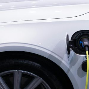 Electric vehicle plugged into a public charging station in California daylight