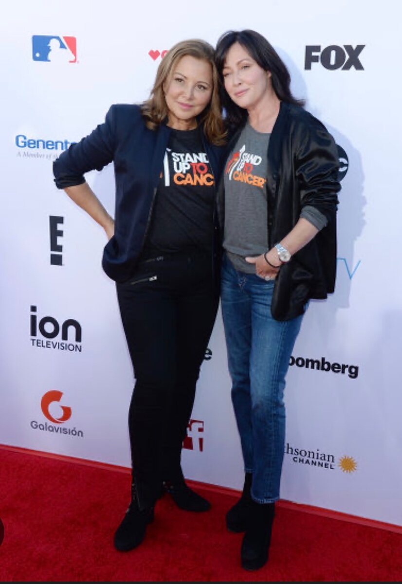 Stylist Deborah Waknin-Harwin and actress Shannen Doherty together at a Stand Up to Cancer event, both wearing Stand Up to Cancer shirts