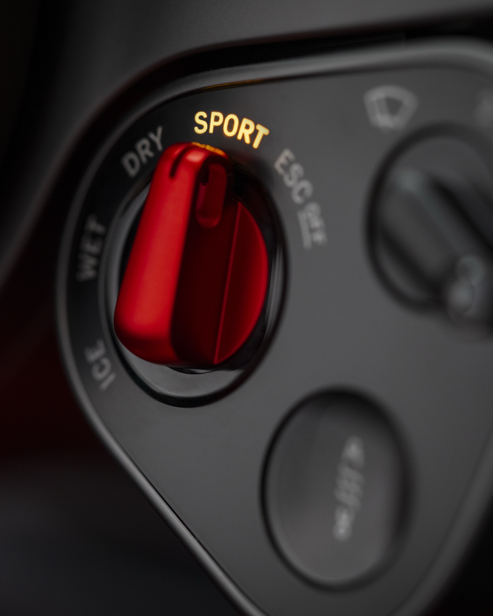 2026 Ferrari Luce Manettino dial detail showing the red anodized dial set to Sport with Ice, Wet, Dry, Sport, and ESC Off positions