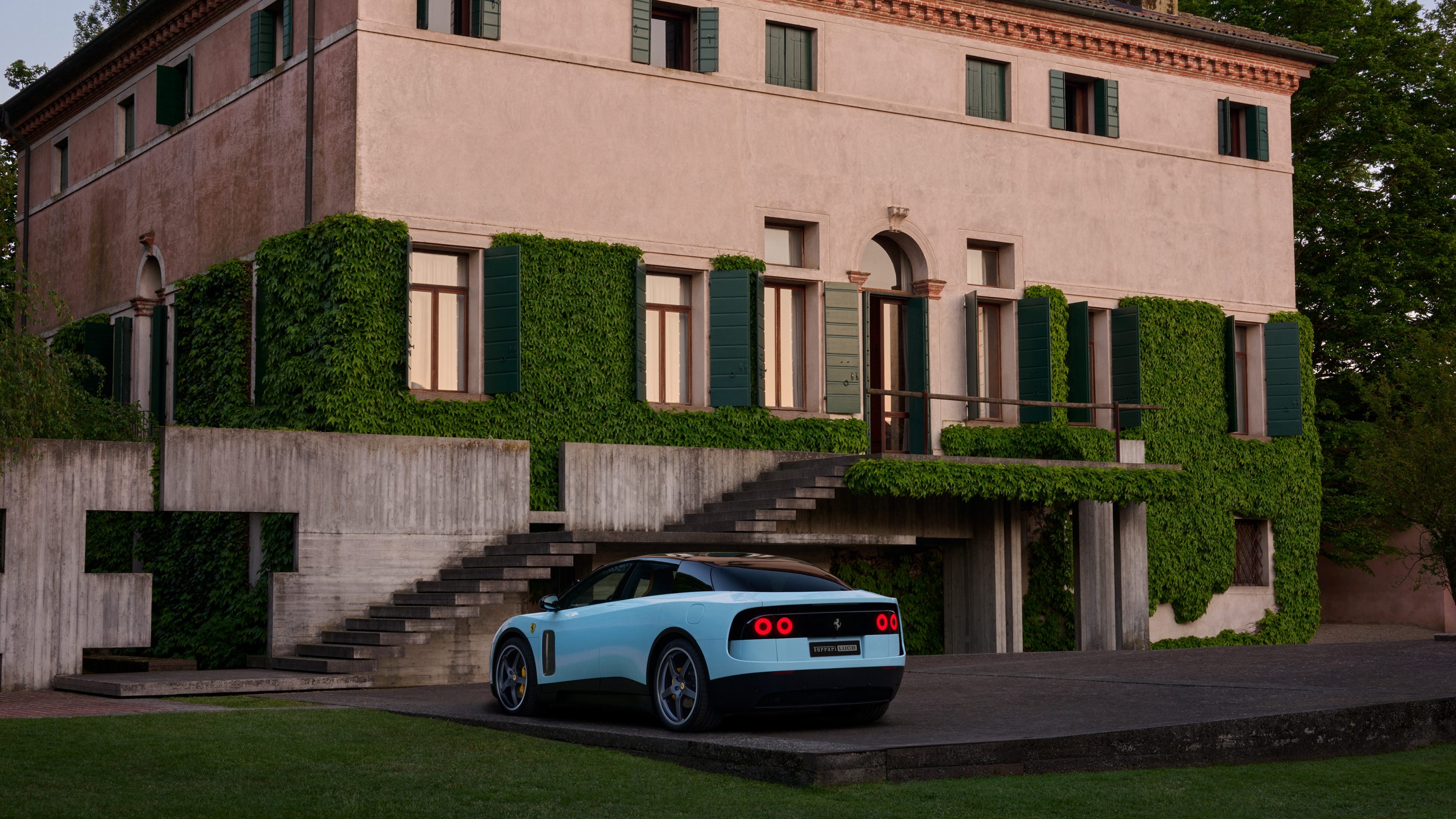 2026 Ferrari Luce rear three-quarter view showing the floating rear aerodynamic wing and halo tail-light treatment
