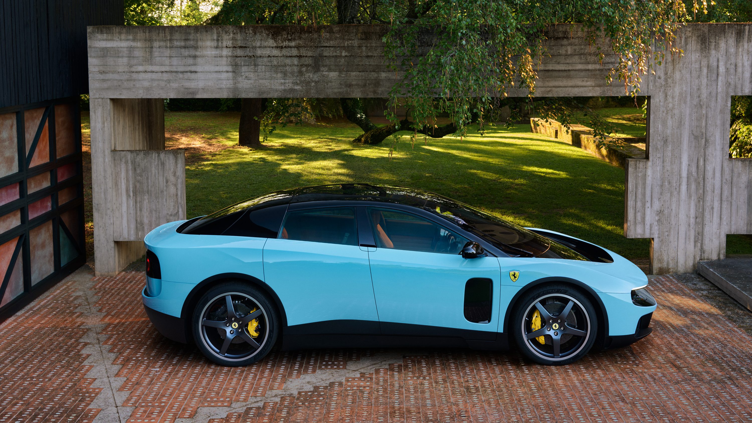 2026 Ferrari Luce side profile showing the uninterrupted glass house silhouette and floating front and rear aerodynamic wings