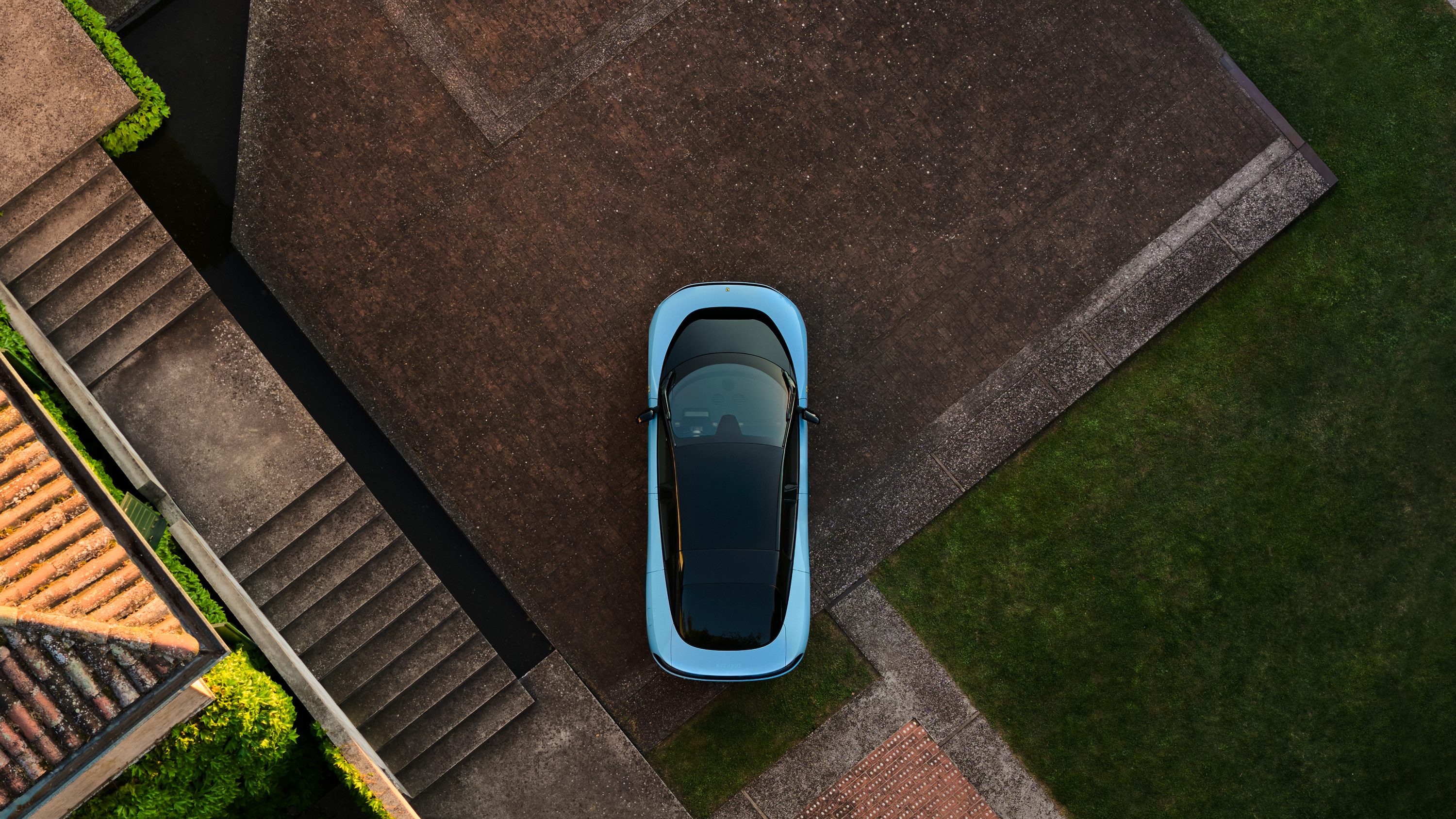 2026 Ferrari Luce overhead view showing the four-door, five-seat layout, glass roof, and active aerodynamic surfaces