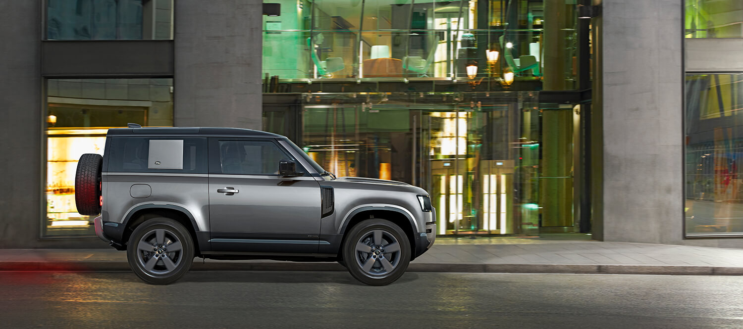 Land Rover Defender 110 X-Dynamic exterior, the trim with the same 3.0L Ingenium I6 mild-hybrid engine, ZF 8-speed transmission, and 8,200-pound tow rating as the 2026 Range Rover SE SWB P400, on the D7x aluminum monocoque platform