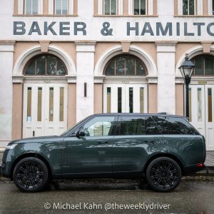 2026 Range Rover SE SWB P400 in Belgravia Green in side profile parked on cobblestones in front of the historic Baker and Hamilton facade in Old Sacramento