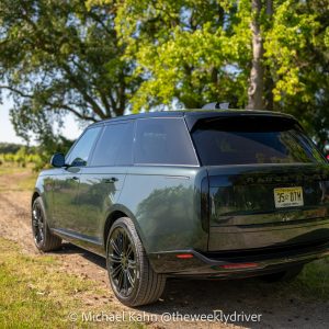 2026 Range Rover SE SWB P400 in Belgravia Green parked on a dirt track at a vineyard, rear three-quarter view in golden-hour light