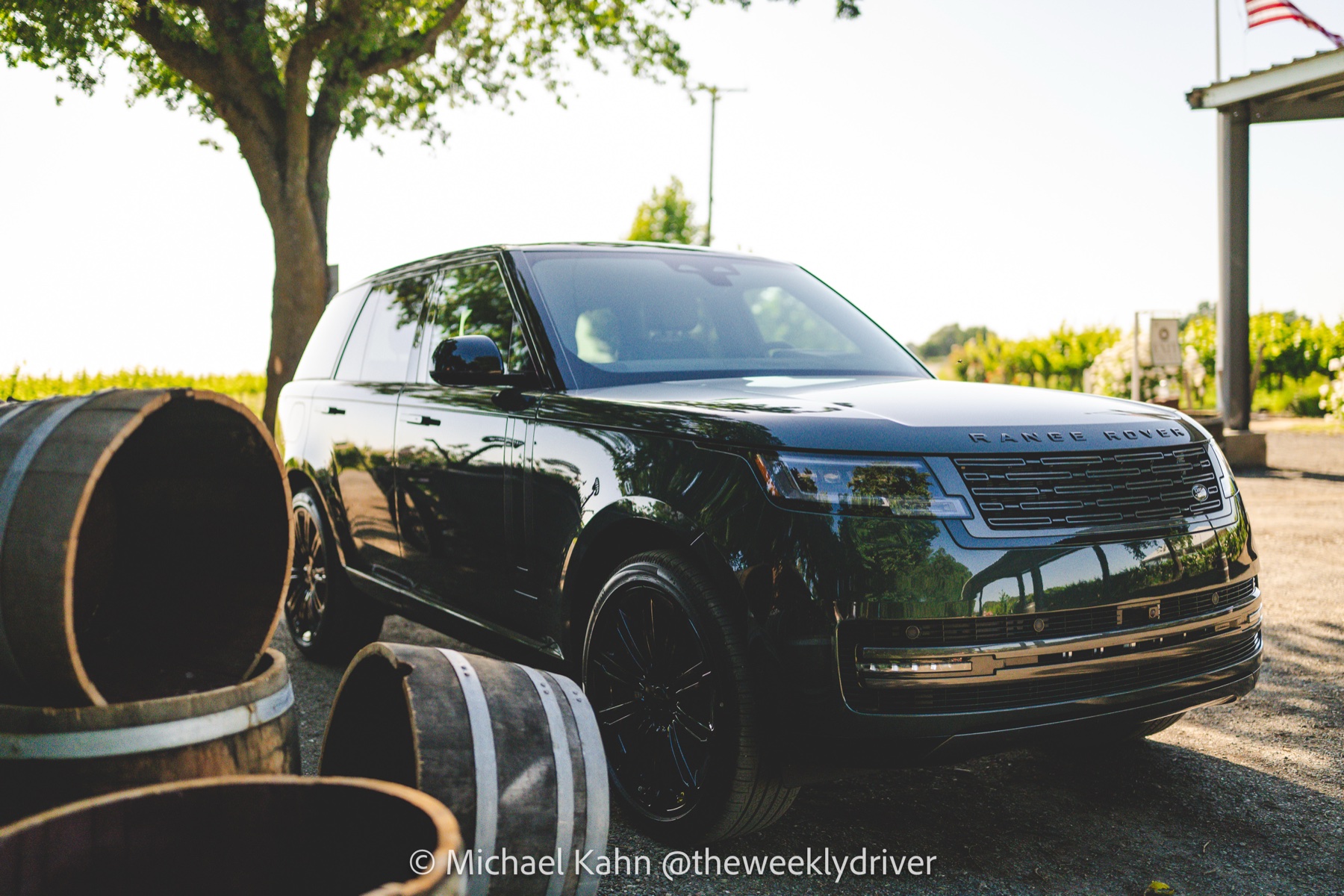 2026 Range Rover SE in Belgravia Green parked in front of stacked wooden wine barrels at Heringer Estate with vineyards in the background