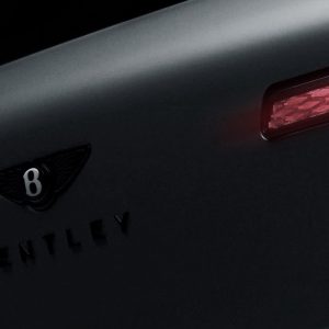 Bentley Torcal teaser image showing the rear of Bentley's first electric SUV, with slim diamond-pattern taillights and a darkened Bentley badge