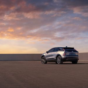 A silver 2026 Cadillac Optiq electric SUV at sunset, the US-market model that keeps its Ultium platform regardless of GM's China plans