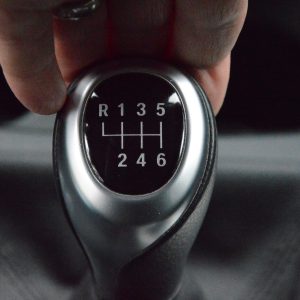 Driver's hand on a six-speed manual gearshift lever