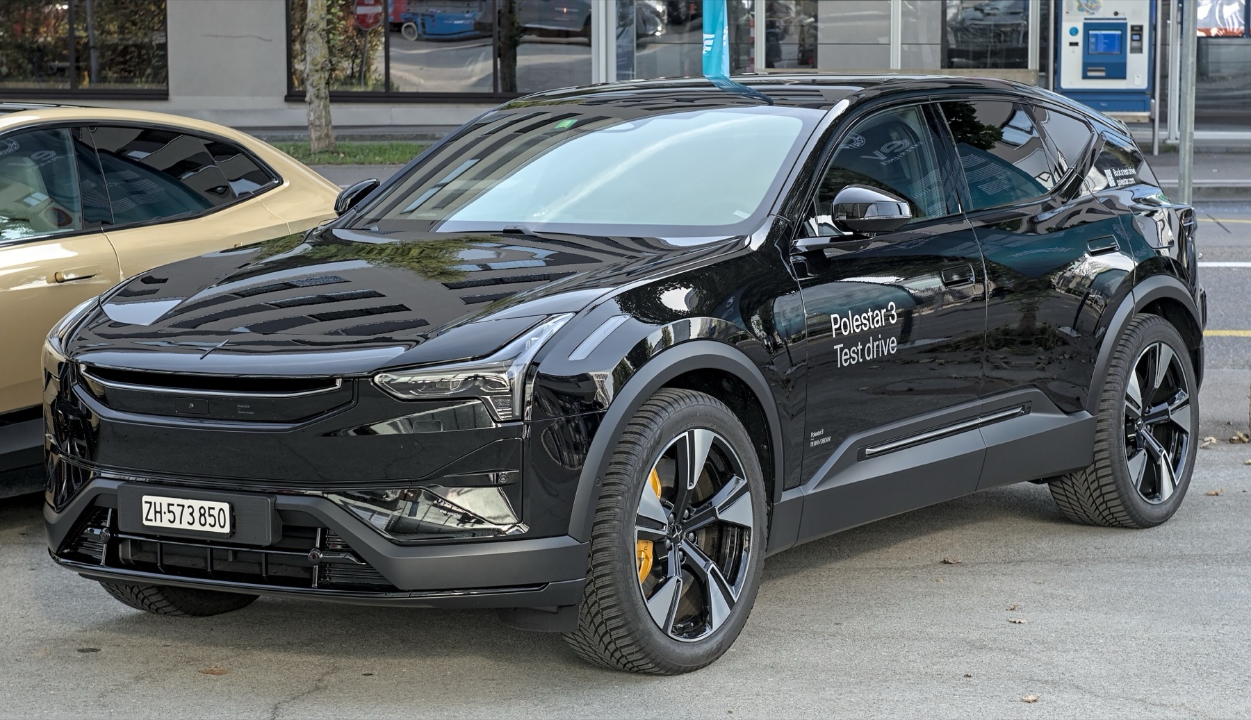 A black Polestar 3 SUV marked with test drive lettering on the door at a European motor show