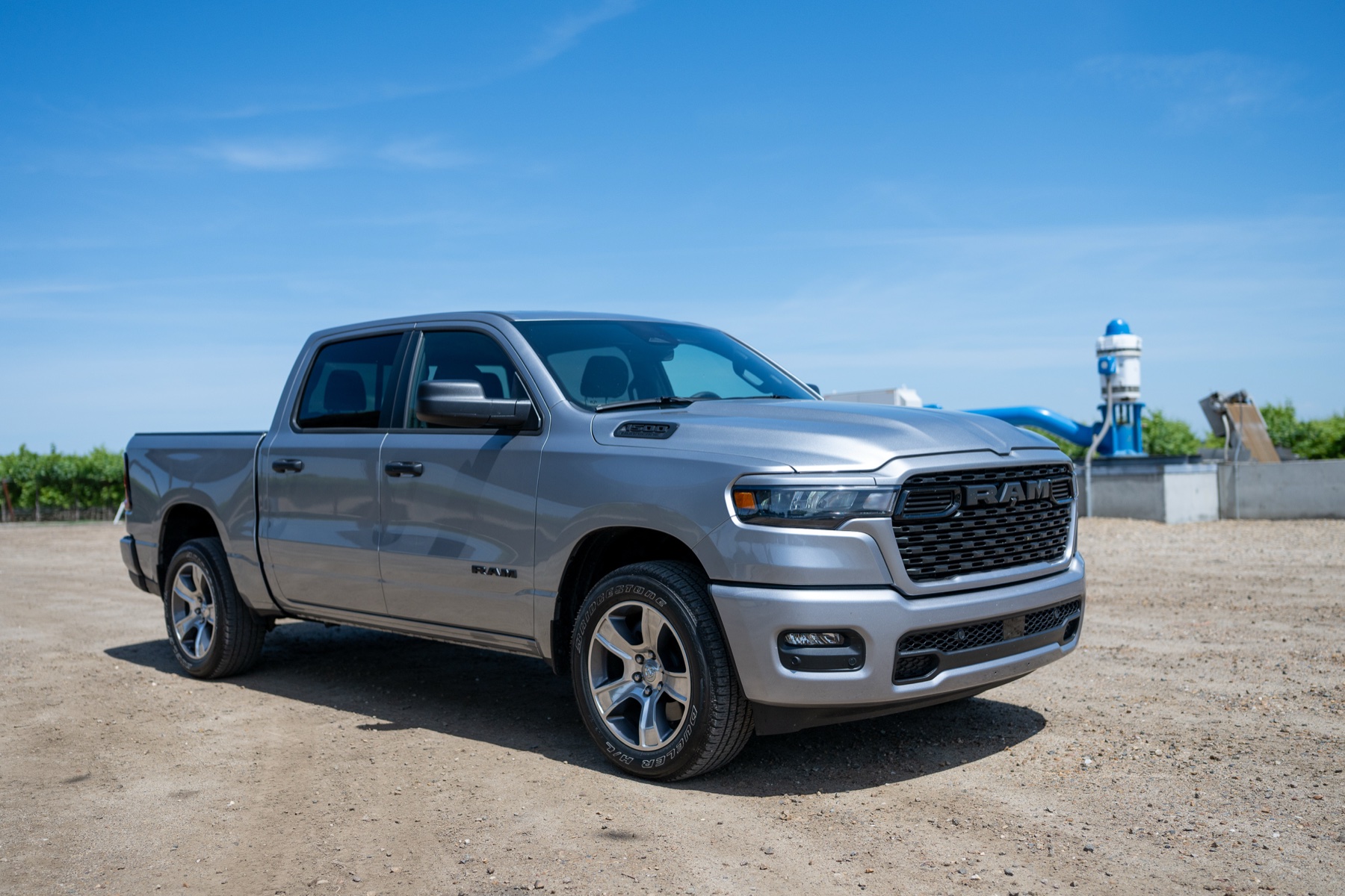 2026 RAM 1500 Express Billet Silver: Low front three-quarter in the orchard