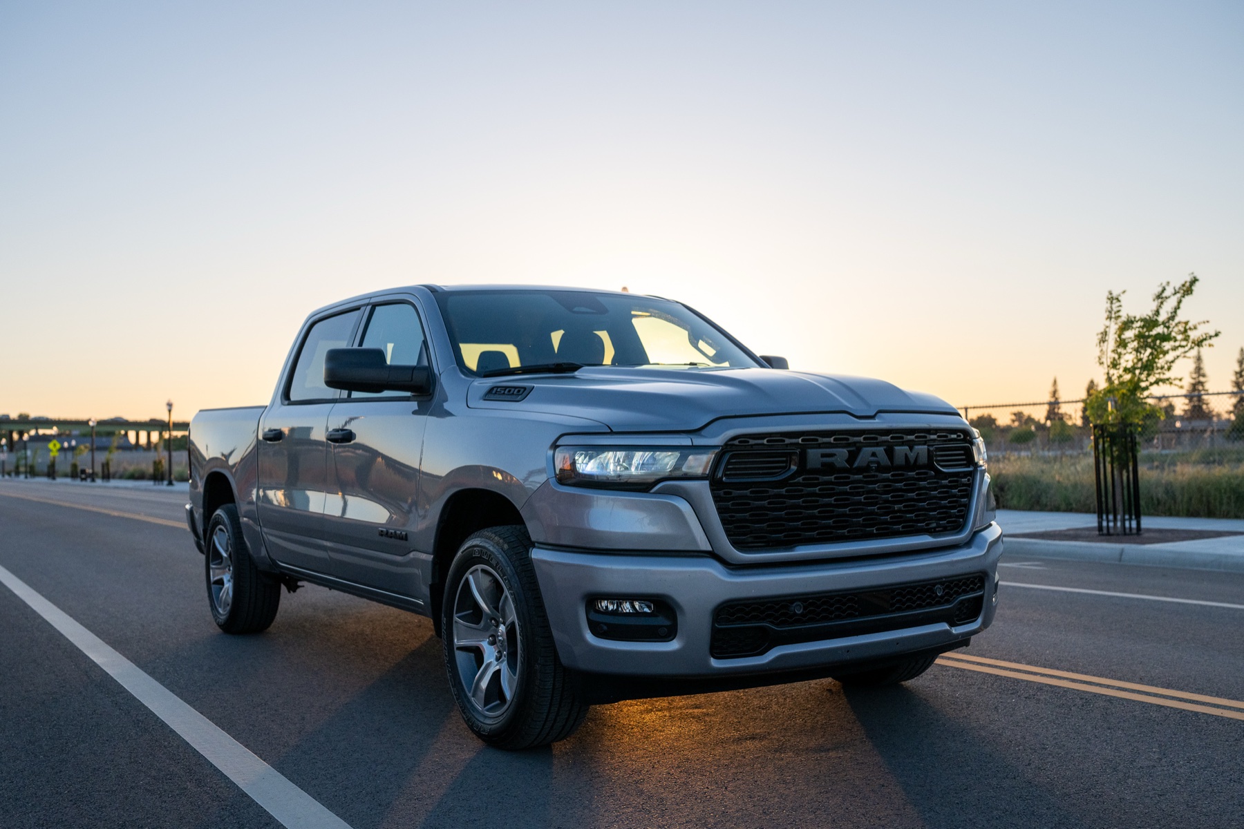 2026 RAM 1500 vs Toyota Tundra: The Work-Truck Cross-Shop 1 2026 RAM 1500 Express in Billet Silver Metallic, front three-quarter on an urban road