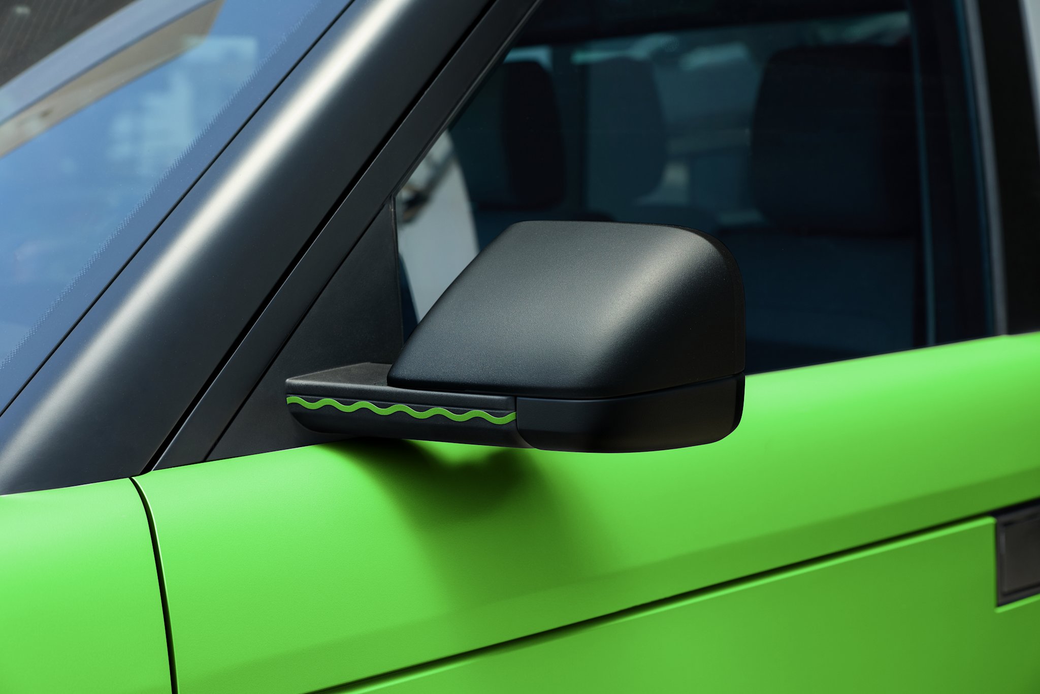 Green Crayola serpentine-stripe decal on the side mirror of a Slate Truck in Fern wrap