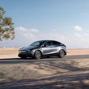 A grey 2026 Tesla Model Y on a desert road, the model Tesla advertises from $39,990 before fees