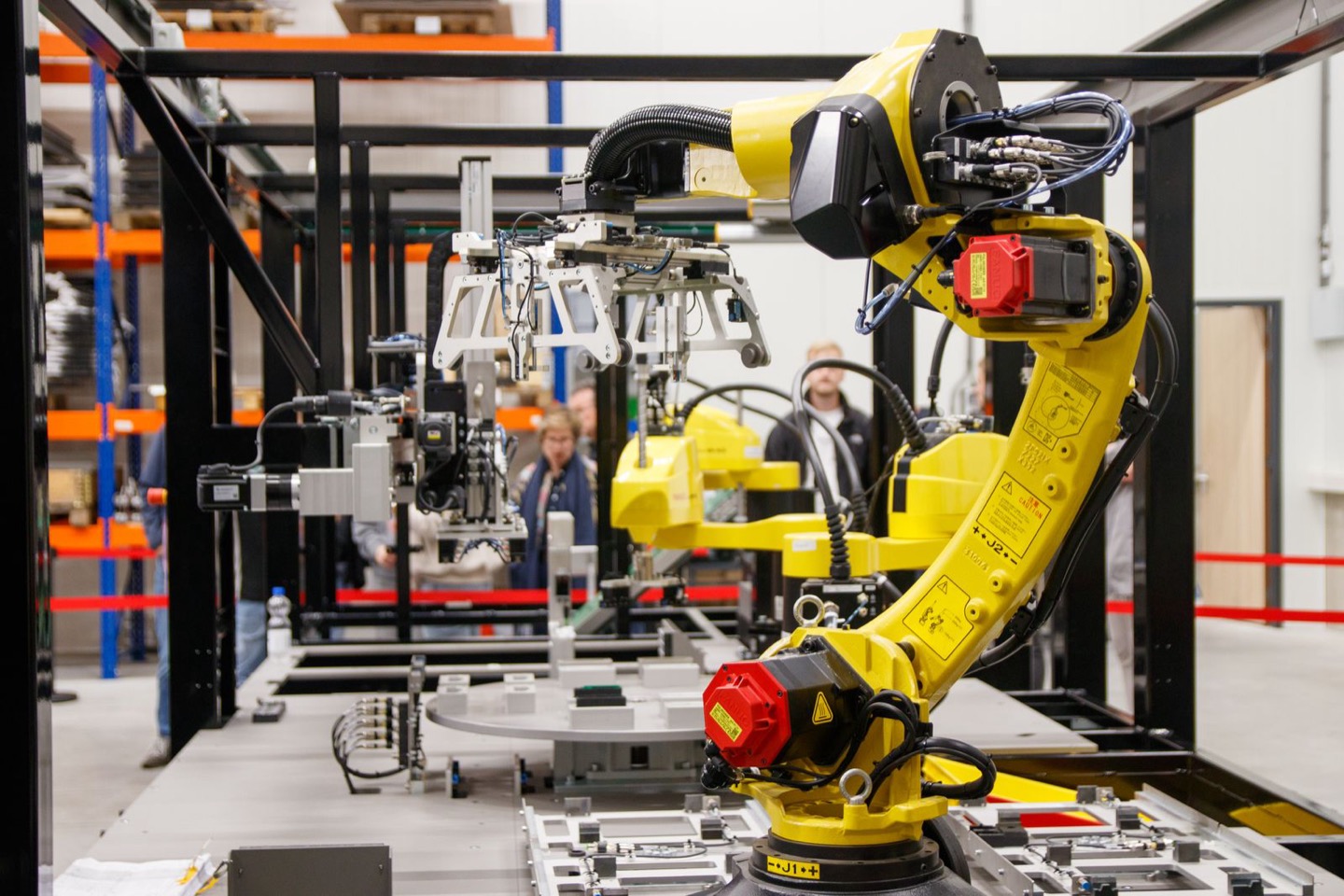 Home 1 Yellow industrial robot arms on a manufacturing line, the kind of assembly-line equipment Toyota plans to simulate with Nvidia digital twins
