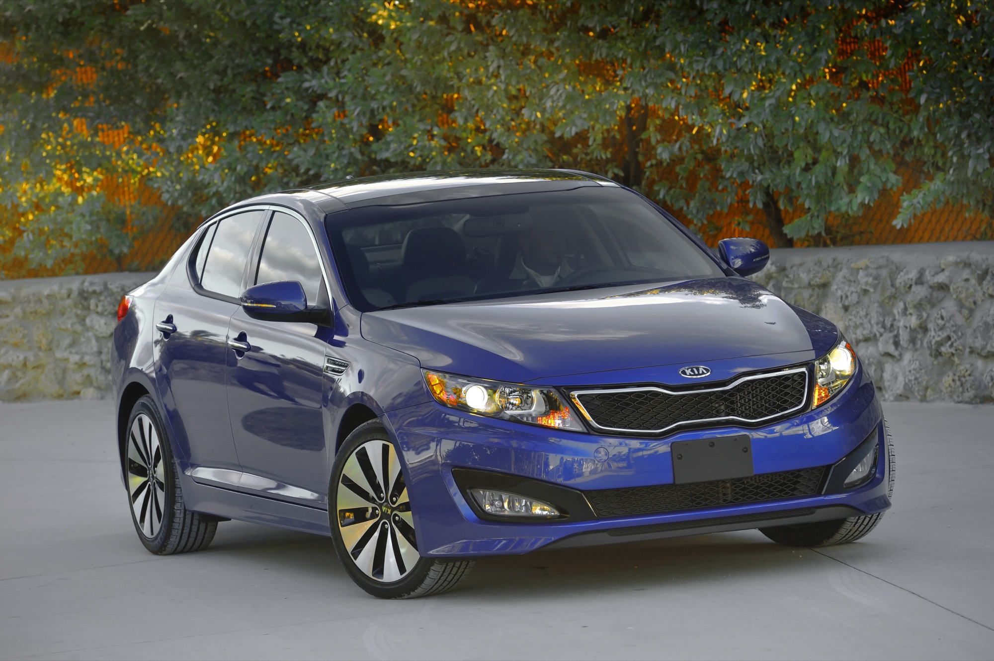 2011 Kia Optima midsize sedan in blue, front three-quarter view