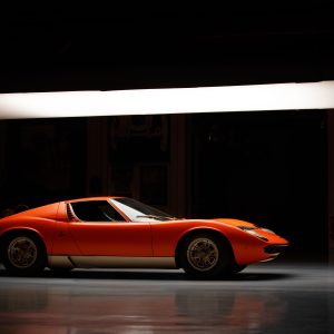 Side profile of a vintage Lamborghini Miura under studio lighting