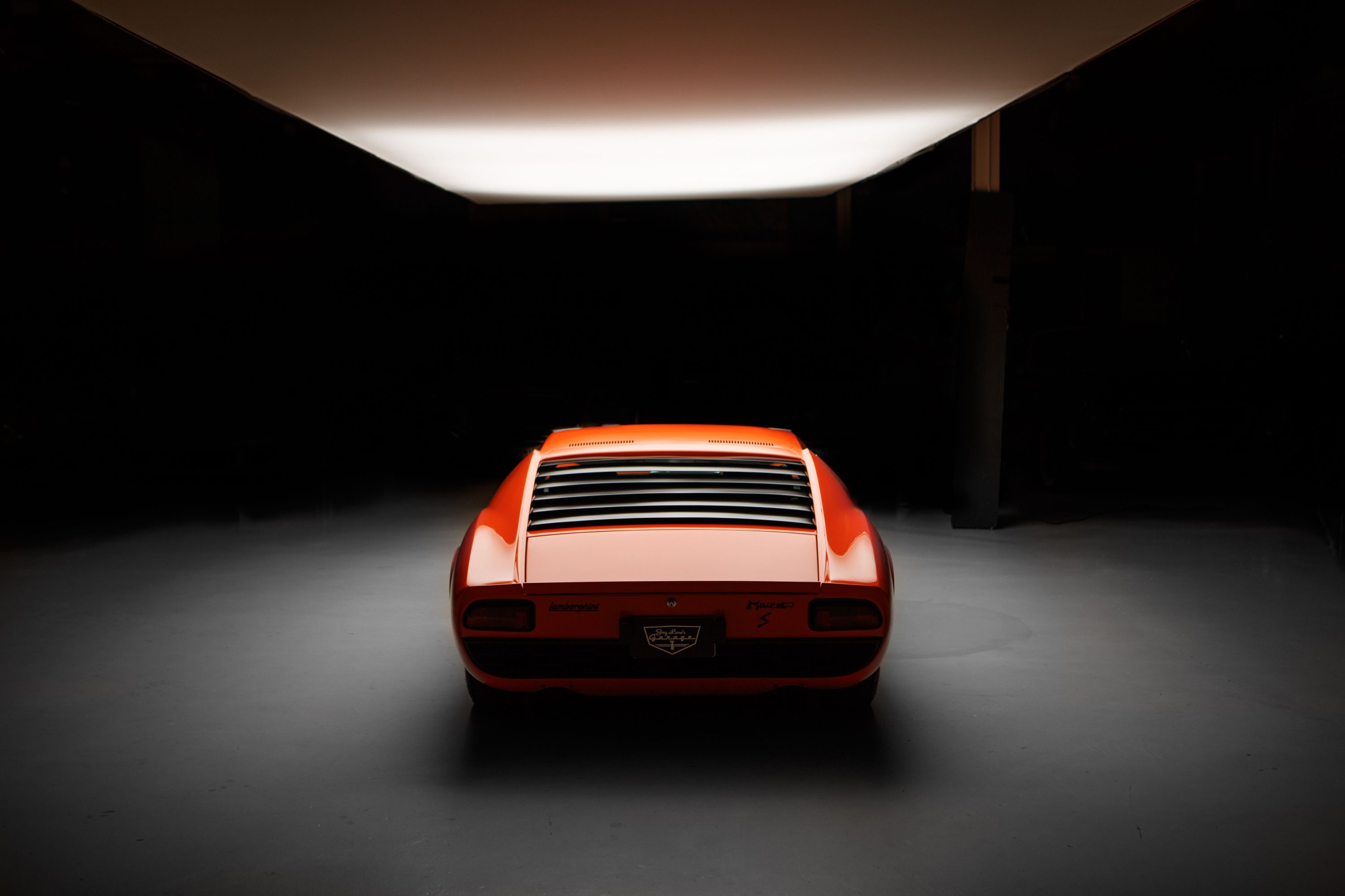 Rear view of a classic orange Lamborghini Miura