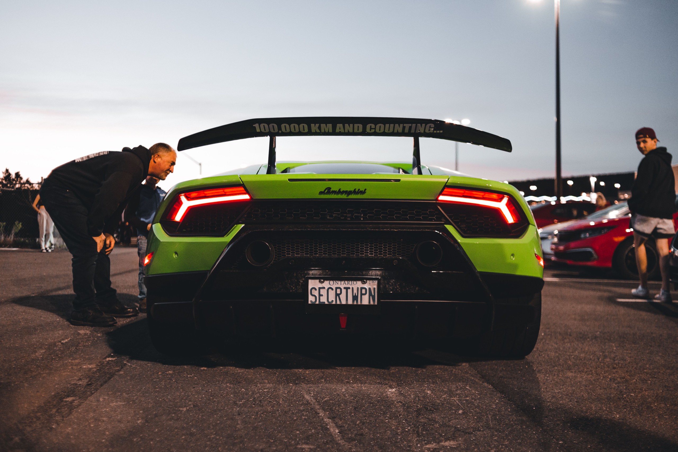 Luxury sports car parked outside an upscale venue at an automotive event