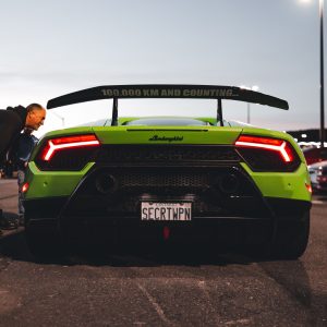 Luxury sports car parked outside an upscale venue at an automotive event