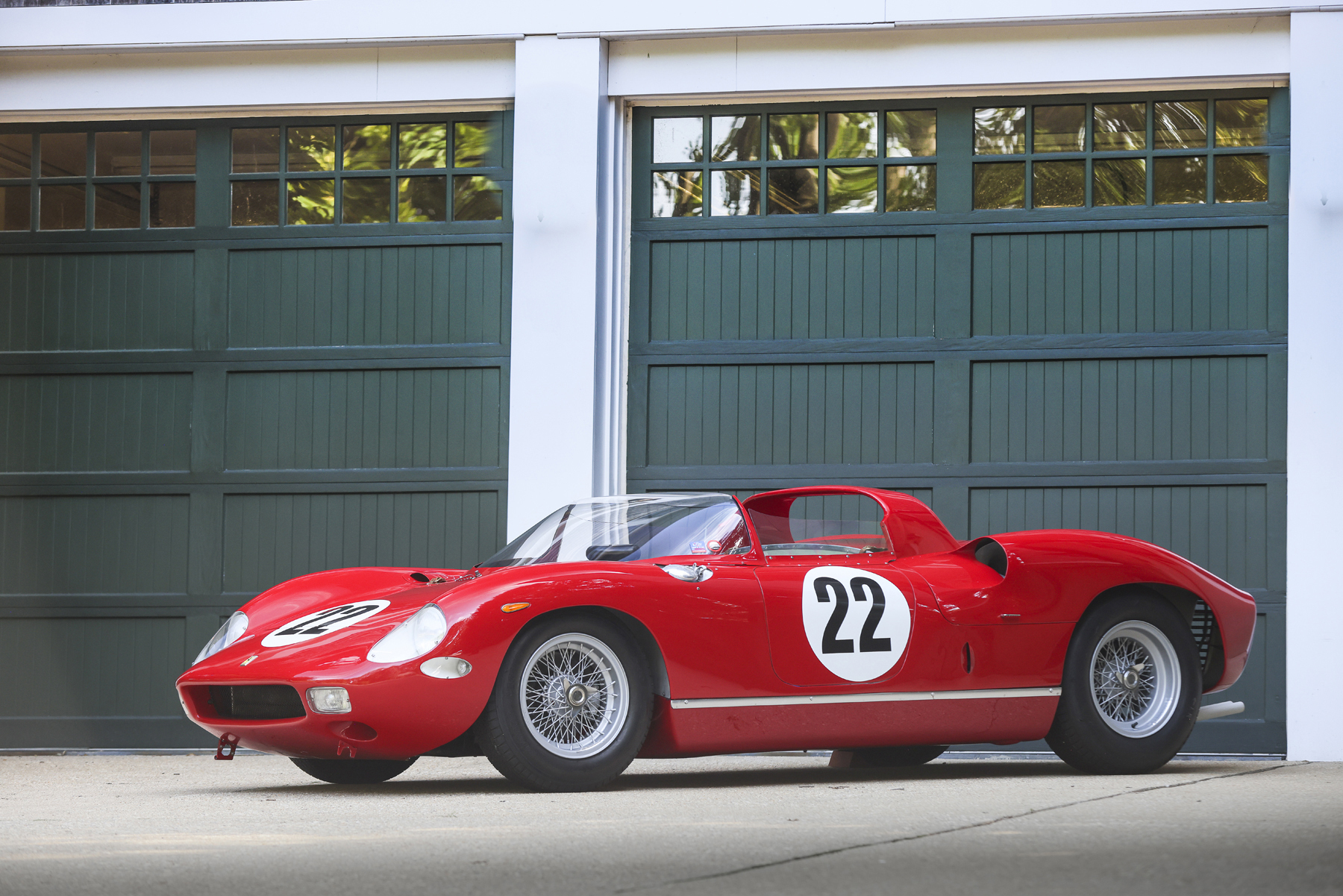 Red 1963 Ferrari 250 P mid-engine sports racing prototype with number 22 roundels