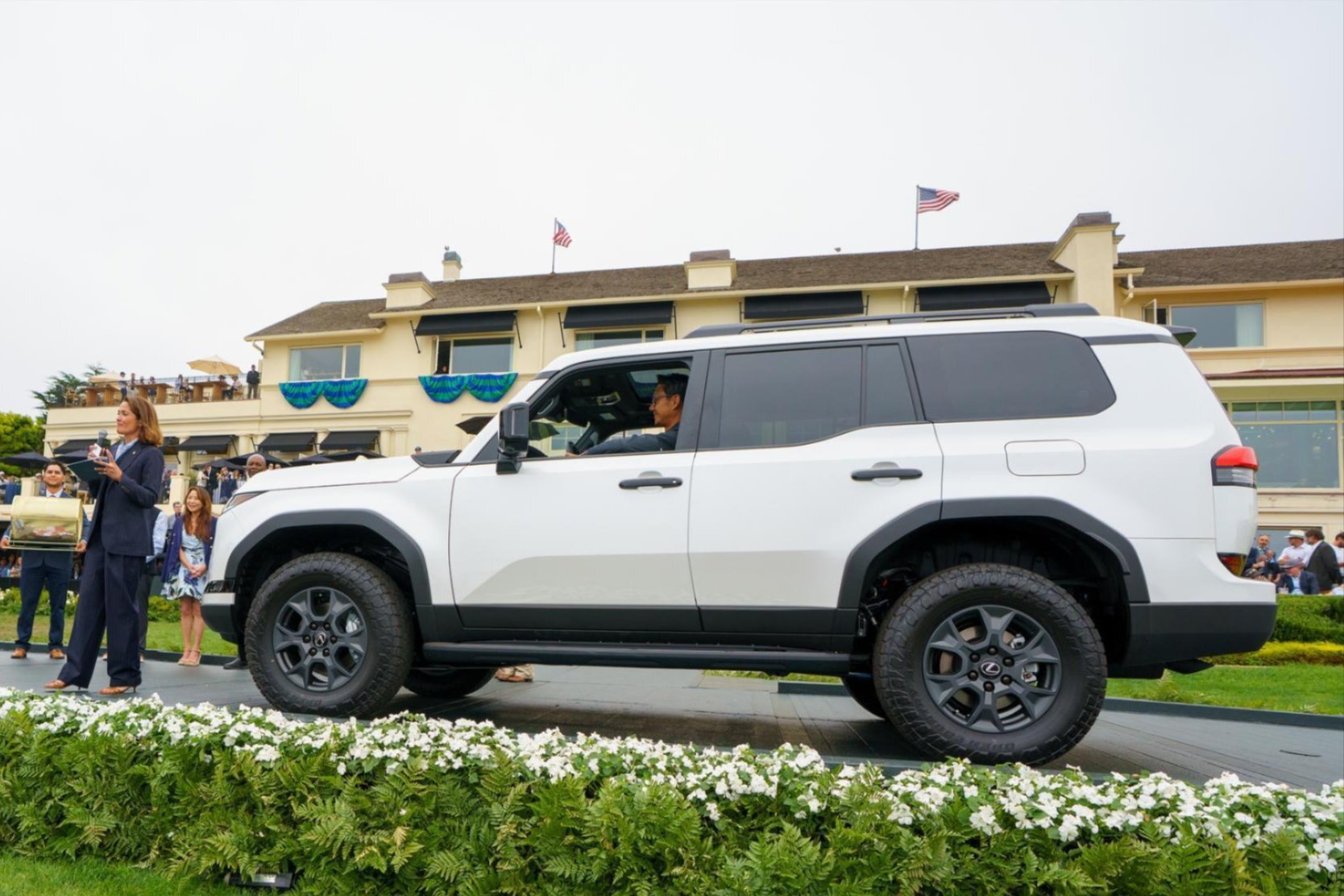 White Lexus GX SUV presented on the Pebble Beach ramp as a Charity Drawing prize vehicle