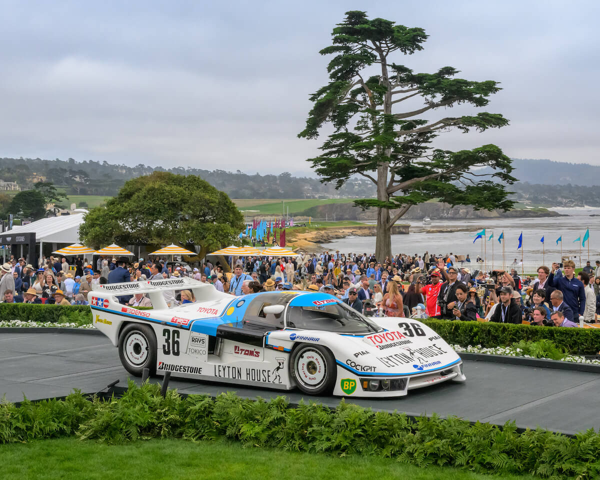 1985 Toyota 85C L Longtail Group C Le Mans coupe in white and blue Leyton House livery on the Pebble Beach awards ramp