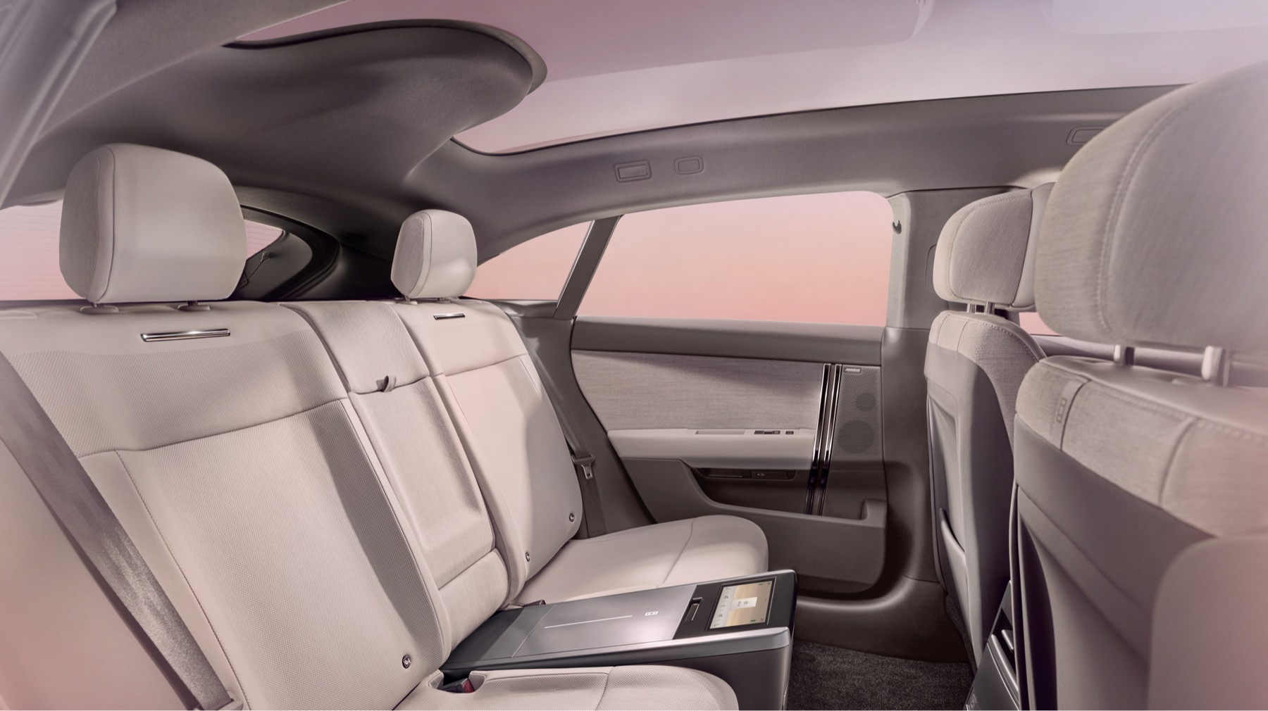 Range Rover GT rear cabin showing woven textile door trim, pale leather seating and the sloping coupé roofline