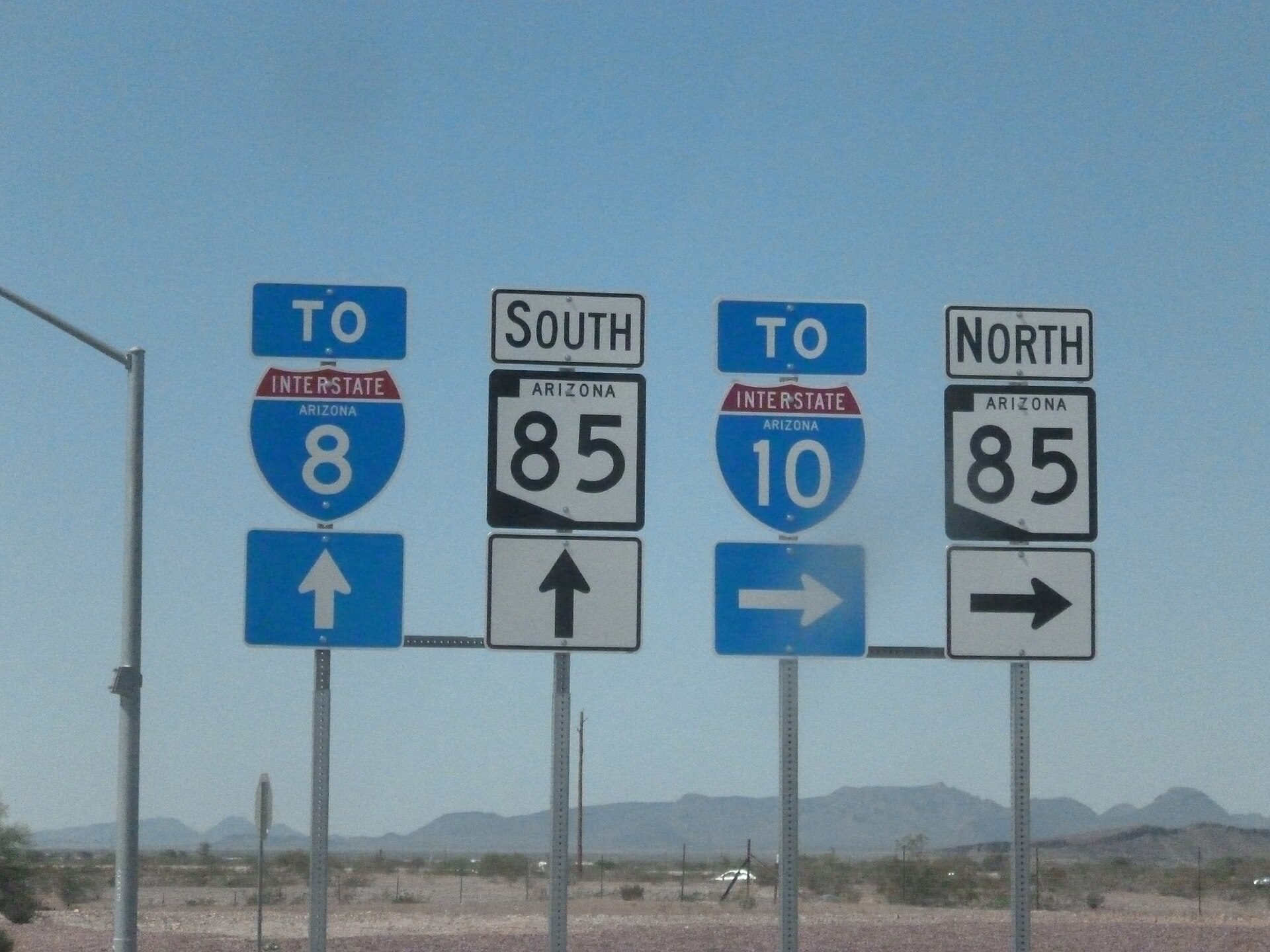 Arizona highway signs showing State Route 85 north and south alongside shields directing traffic to Interstate 8 and Interstate 10, the freight connection SR-85 provides
