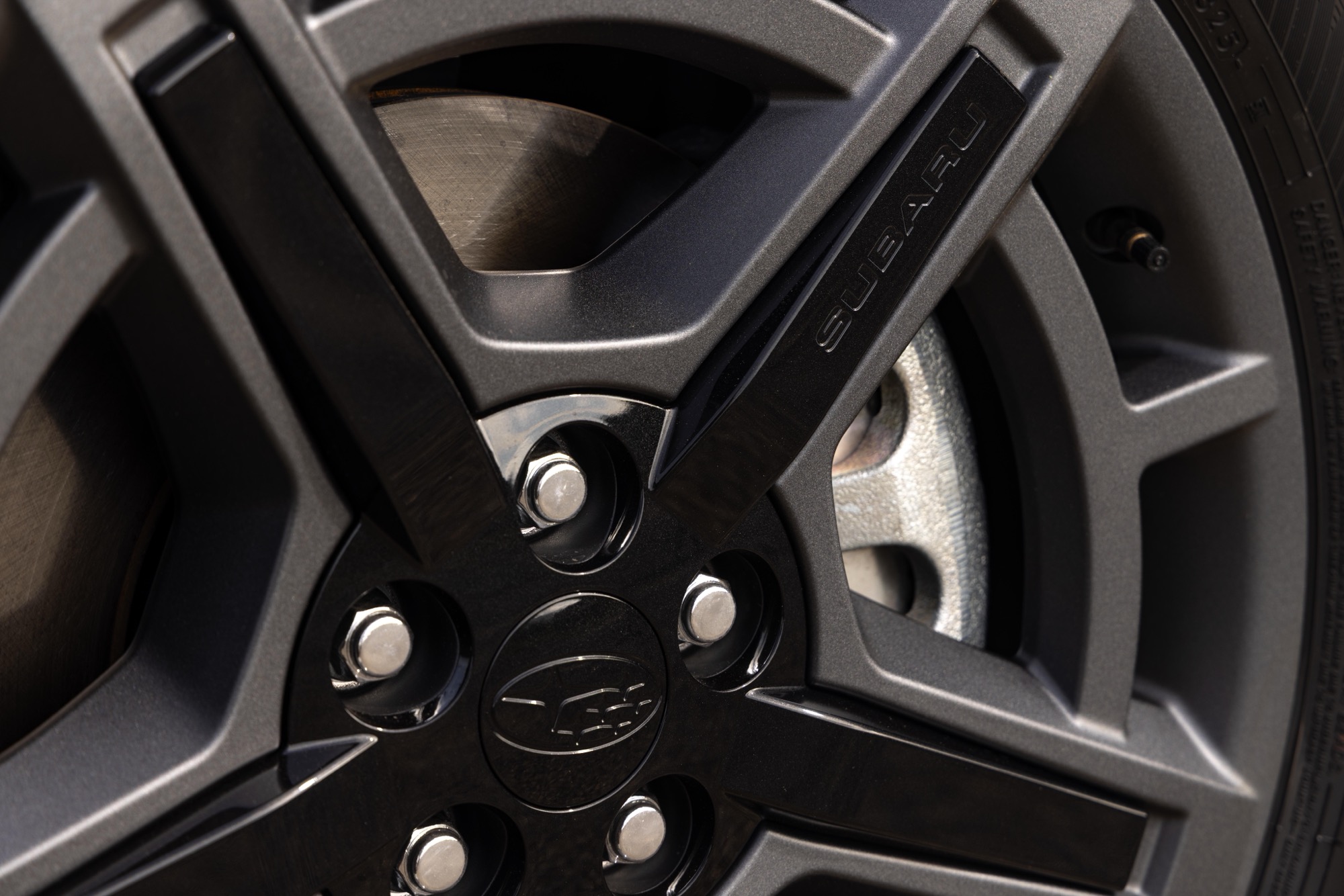 Close-up of a dark alloy wheel and brake rotor on a 2026 Subaru Uncharted