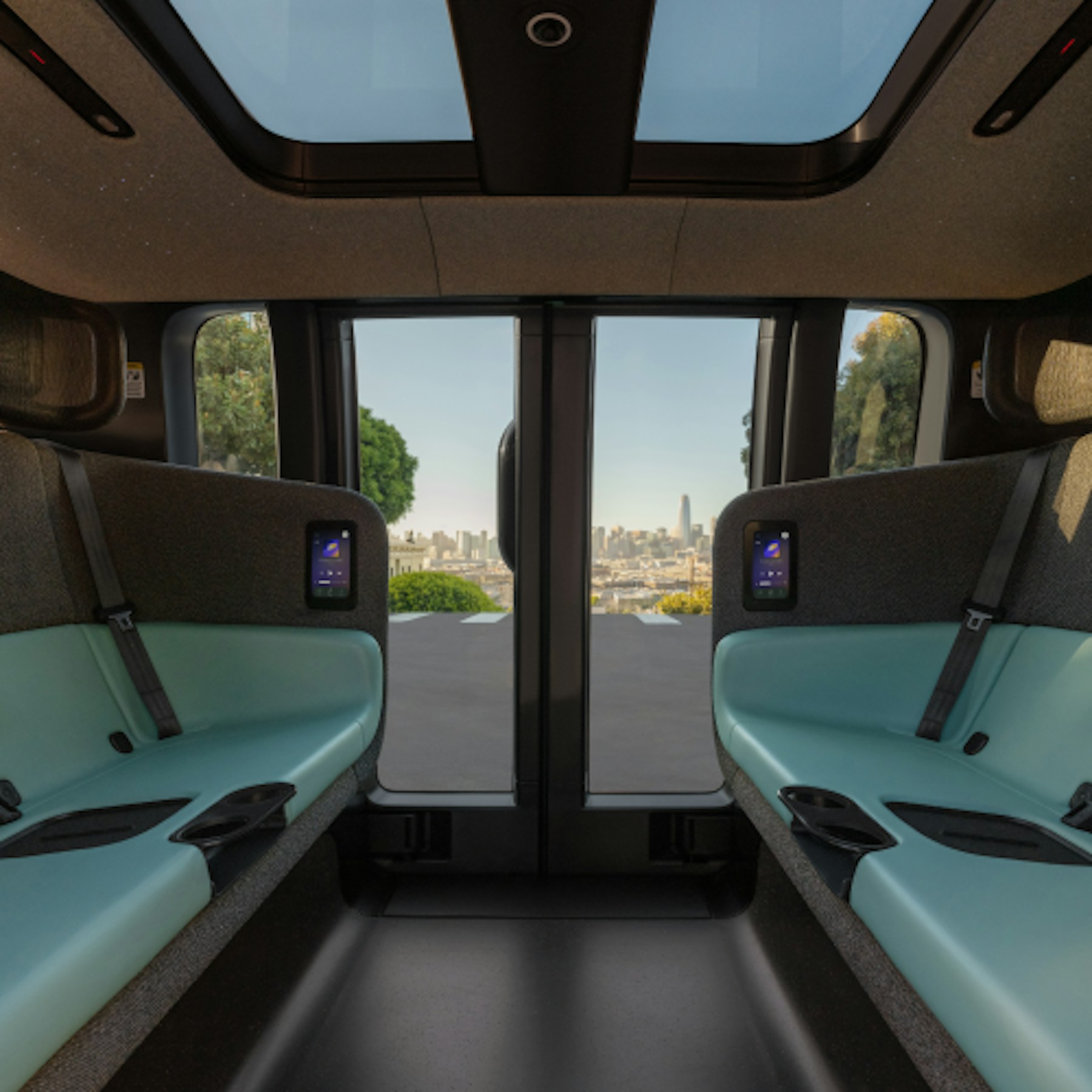Interior of the Zoox robotaxi showing two bench seats facing each other with no steering wheel, dashboard, mirrors or sun visors
